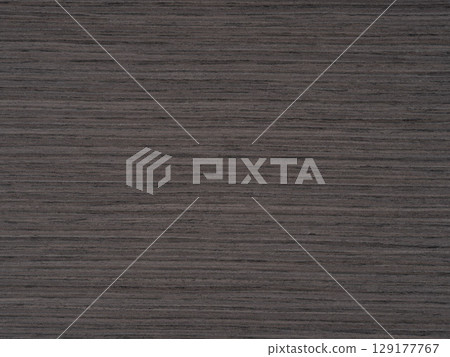 Dark dove grey shades stretch over the textured expanse of oak veneer Dark dove grey shades stretch over the textured expanse of oak veneer 129177767