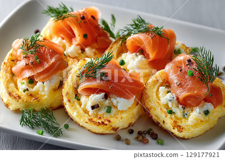 Tasty breakfast. Gourmet high-protein breakfast. Premium Hotel breakfast. Breakfast sushi: scrambled eggs and smoked salmon rolls. Viral food trend. 129177921