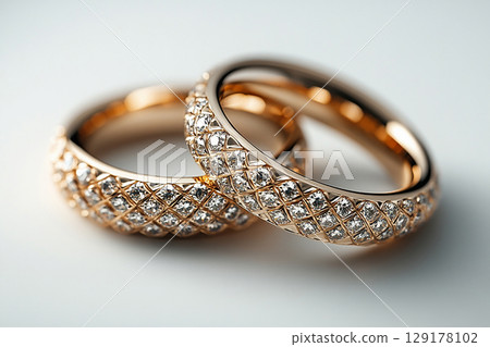 Pair of white gold wedding rings on a white background. 129178102