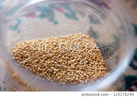 Close-up of raw quinoa in a glass jar. Superfood. Storage concept 129178240