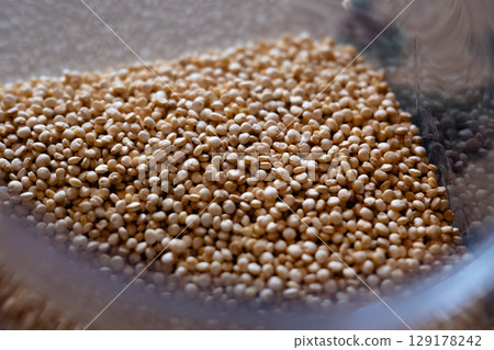 Close-up of raw quinoa in a glass jar. Superfood. Storage concept 129178242
