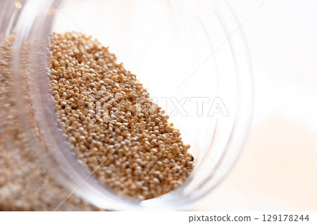 Close-up of raw quinoa in a glass jar. Superfood. Storage concept 129178244