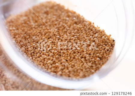 Close-up of raw quinoa in a glass jar. Superfood. Storage concept 129178246