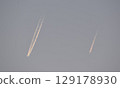 Two airplanes flying in the evening sky 129178930