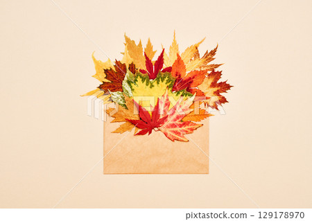 Autumn leaves on beige background 129178970