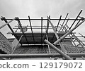 Scaffolding surrounding on a house 129179072