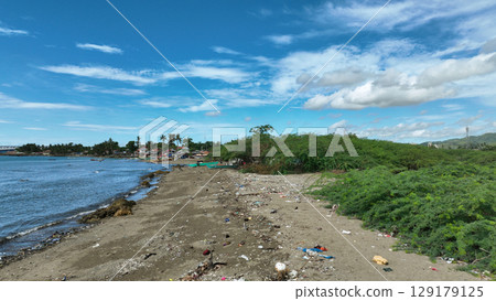 Garbage beach plastic waste Cebu landfill ocean pollution bottles coast water trash fishermen litter boats poor people shanty fishing nets Philippines Taytay sea children people fish beautiful 129179125