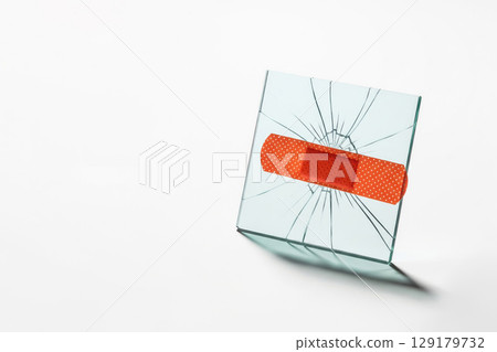 A crack in the glass, sealed with a plaster. Space for text. 129179732