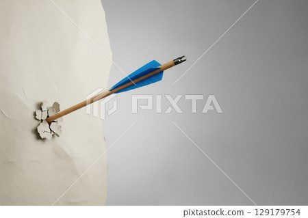 An arrow pierces the wall. Space for text. 129179754