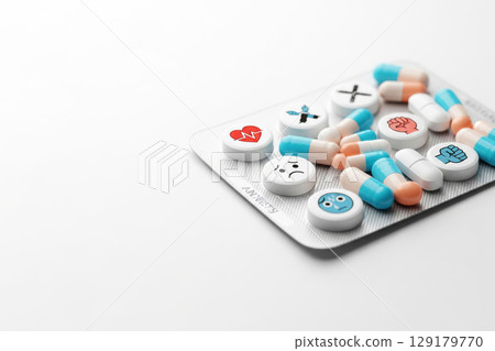 A blister with pills with emotions and symbols on them. Space for text. 129179770