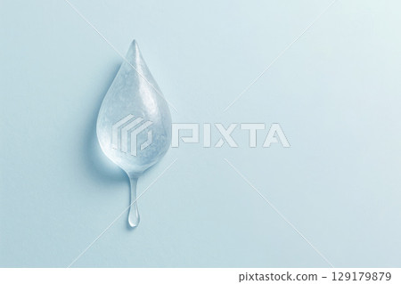 A piece of ice in the shape of a drop on a clean background. Space for text. 129179879