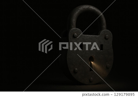 An old rusty lock with a golden ray of light from a keyhole. Space for text. An old rusty lock with a golden ray of light from a keyhole. Space for text. 129179895
