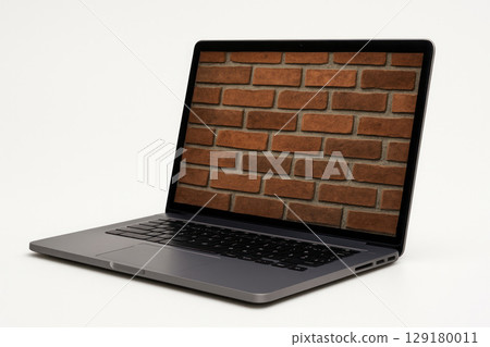 A laptop with an image of a brick wall on the screen. A laptop with an image of a brick wall on the screen. 129180011