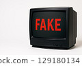 The inscription FAKE on the screen of an old TV on a white background. Space for text. 129180134