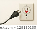 The plug in front of the socket has a hole with a heart icon. Space for text. 129180135