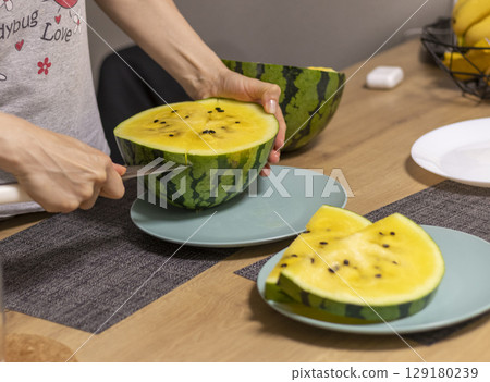 Close up shot of the cut watermelon with yellow flesh on ceramic plate. Close up shot of the cut watermelon with yellow flesh on ceramic plate. 129180239