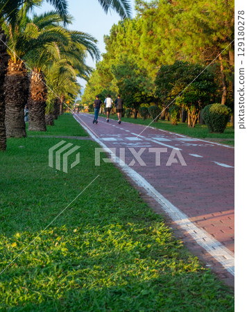 Bike lane concept. Healthy lifestyle. Urban space in a modern resort. Smart urbanism. Bicycle path close-up. Bike lane concept. Healthy lifestyle. Urban space in a modern resort. Smart urbanism. Bicycle path close-up. 129180278