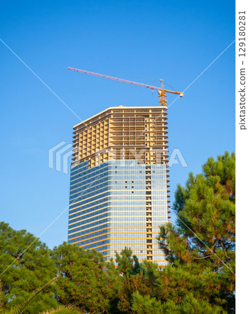 Skyscraper glazing. Finishing work. Modern building. Park and new buildings. 129180281