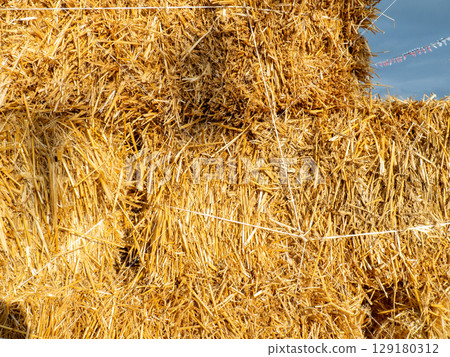 Hay background. Straw blocks. Heap of dry grass. Animal food. Rural life concept Hay background. Straw blocks. Heap of dry grass. Animal food. Rural life concept 129180312
