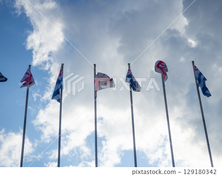 Flags against the sky. Flags of Georgia and Adjara.  State symbols. 129180342