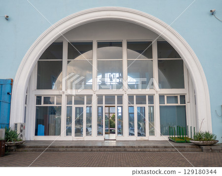 Semicircle of the facade of the building. Beautiful facade of the port building. 129180344