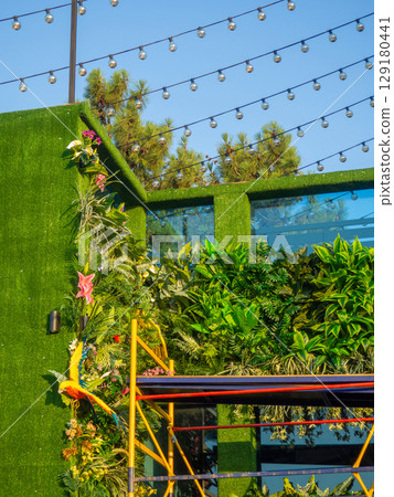 Facade of the building in green matter. Preparations for decorative work. Building reconstruction. Beautiful facade Facade of the building in green matter. Preparations for decorative work. Building reconstruction. Beautiful facade 129180441