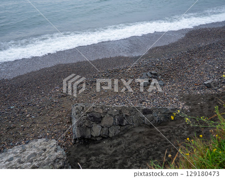 Old blocks of fortifications of the coast. Concrete structures on the shore. Protection against storms, waves and avalanches. Old blocks of fortifications of the coast. Concrete structures on the shore. Protection against storms, waves and avalanches. 129180473