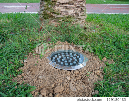 Street illumination lamp in the ground. Lantern in the ground. Palm lighting 129180483
