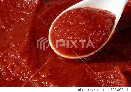 Concentrated Tomato Paste in a Spoon. Natural Red Cooking Ingredient. 129180944