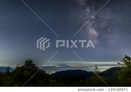 Tengu Rock, the Sword of the Sky, shining in the starlight and the Milky Way over Mount Fuji 129180971
