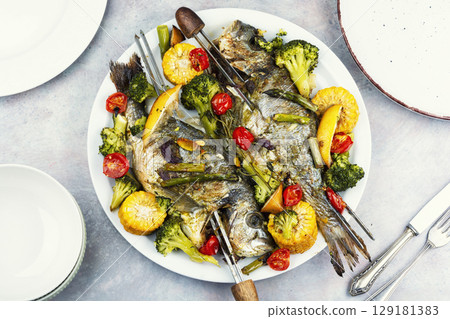Roasted Dorada fish with vegetables. Roasted Dorada fish with vegetables. 129181383
