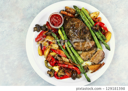 Roasted duck breast with vegetables. 129181398