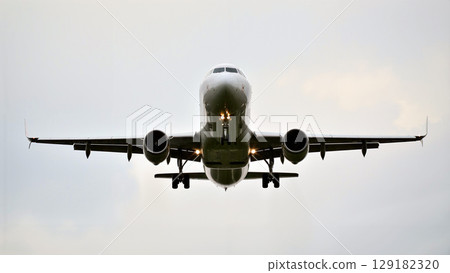 Airplane Flying High Above Clouds During Day With Clear Sky Airplane Flying High Above Clouds During Day With Clear Sky 129182320