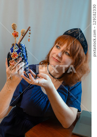 modern woman with elements of ethno-style in a costume uses the technique modern woman with elements of ethno-style in a costume uses the technique 129182330