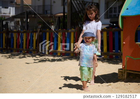 Children Enjoying Playtime at a Colorful Outdoor Playground on a Sunny Day 129182517