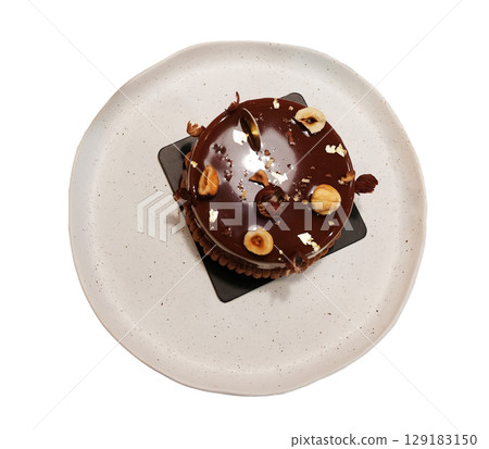 Homemade fresh Chocolate Hazelnut cake on white dish isolated on white background with clipping path. Top view Homemade fresh Chocolate Hazelnut cake on white dish isolated on white background with clipping path. Top view 129183150
