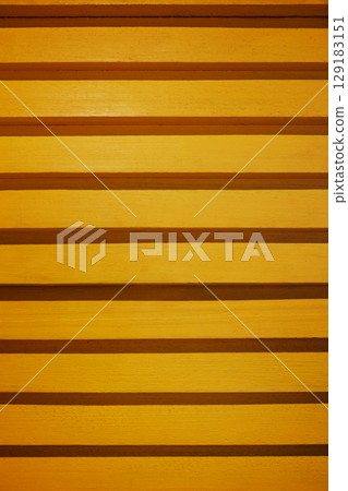 Yellow wooden slatted panel wall texture and background 129183151