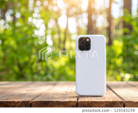 Smartphone case mockup with fresh green forest and sunlight filtering through the trees Smartphone case mockup with fresh green forest and sunlight filtering through the trees 129183239