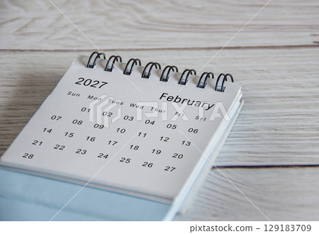 Close up of February 2027 calendar on wooden background 129183709