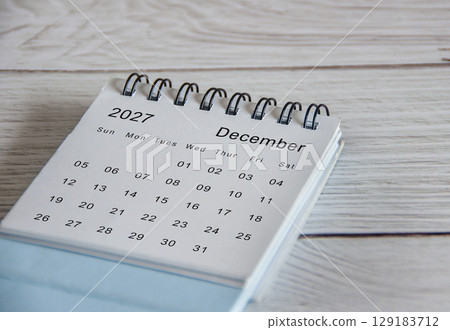 Close up of December 2027 calendar on wooden background 129183712