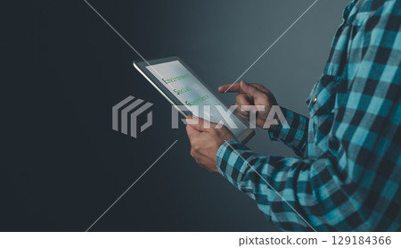 person uses a tablet touchscreen to promote energy savings, reduce global warming, and support eco-friendly investment, ESG principles, green business innovation, and sustainable development. 129184366