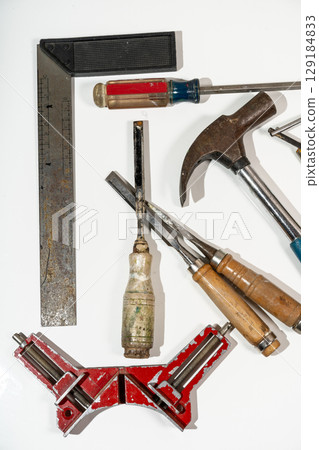 Carpenter tools lying on white background ready for work 129184833
