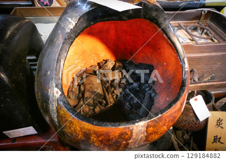 A large gourd-shaped everyday item turned into a charcoal holder 129184882