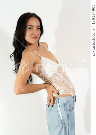 Young latin woman posing with hand on hip, showing confidence and attitude Young latin woman posing with hand on hip, showing confidence and attitude 129184903