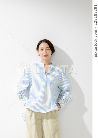 中年婦女微笑著站著 中年婦女微笑著站著 129185291