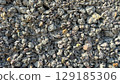 Close-up of a rough concrete wall texture with large aggregate fragments of crushed stone. Ideal as a durable industrial background. 129185306