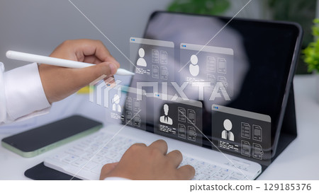 Recruitment technology, Concept of online hiring, human resources, and digital employment process. Businessman reviewing digital resumes on virtual screen using stylus and tablet. Recruitment technology, Concept of online hiring, human resources, and digital employment process. Businessman reviewing digital resumes on virtual screen using stylus and tablet. 129185376