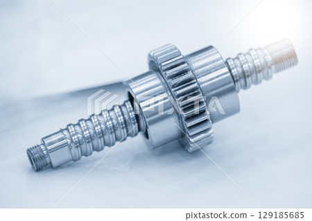 Closeup scene the lead ball screw set and driving gear parts in the blue tone and lighting effect. Closeup scene the lead ball screw set and driving gear parts in the blue tone and lighting effect. 129185685