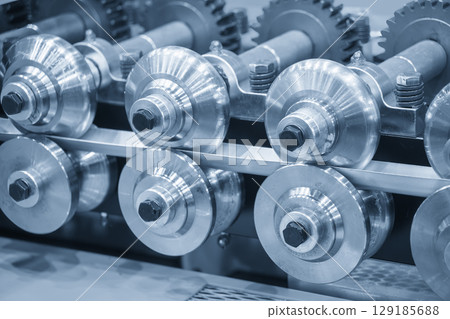 Close up scene the cold roll forming process in the blue tone. 129185688