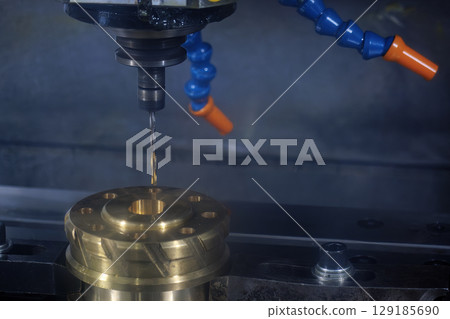 The deep hole drilling process the brass material parts on CNC milling machine. 129185690
